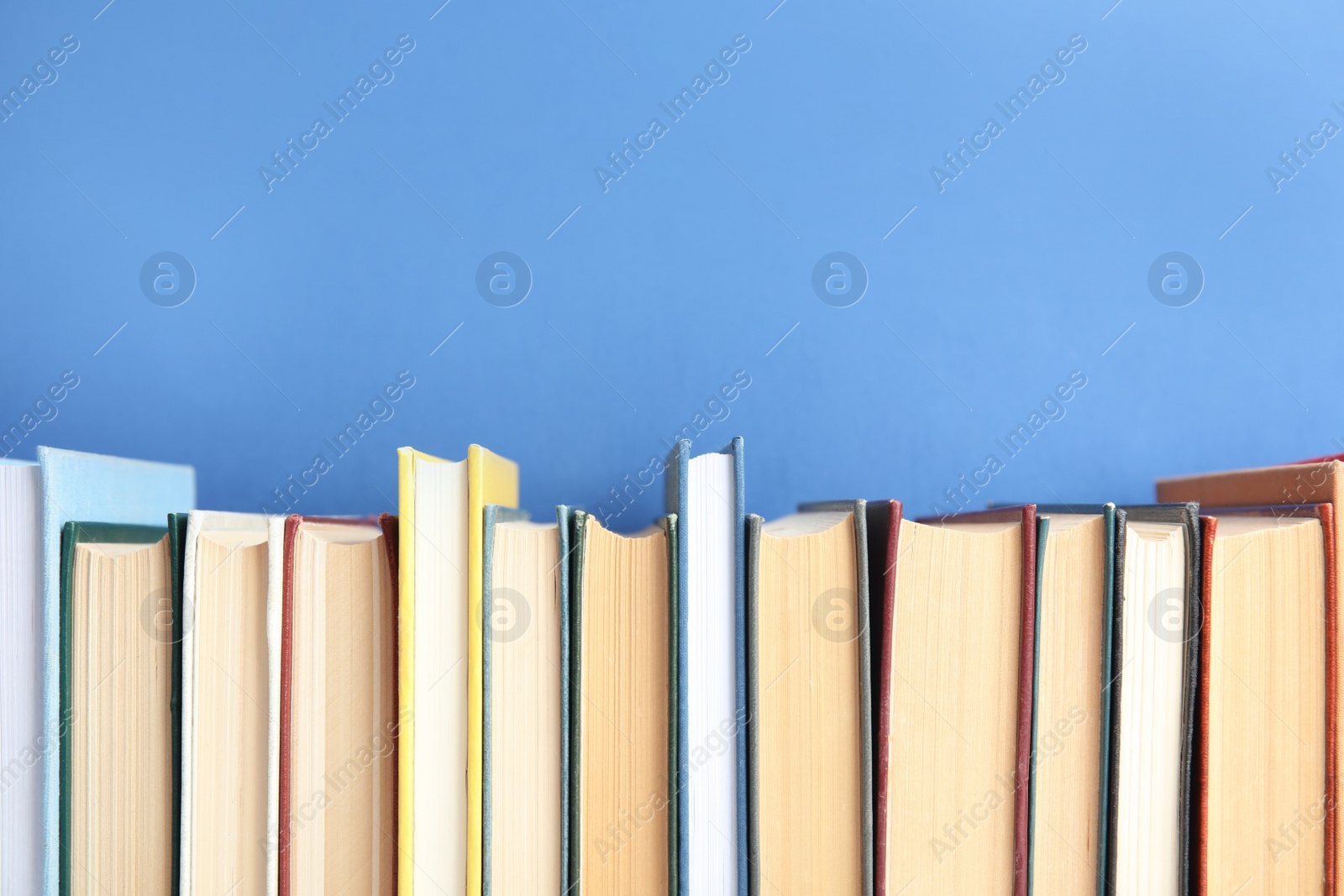 Photo of Collection of old books on blue background