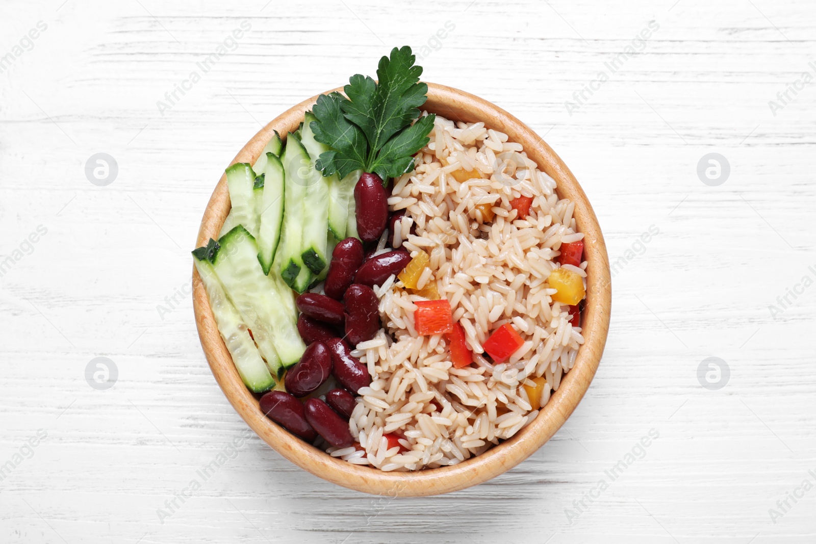 Photo of Delicious rice with beans on white wooden table, top view