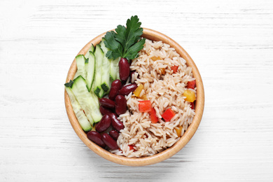 Photo of Delicious rice with beans on white wooden table, top view