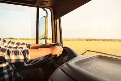 Photo of Man driving modern truck on sunny day, closeup