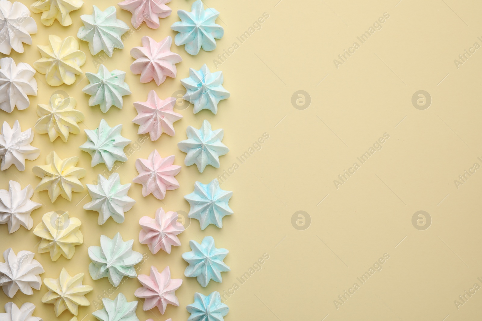 Photo of Delicious meringue cookies on beige background, flat lay. Space for text