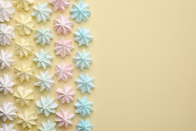 Delicious meringue cookies on beige background, flat lay. Space for text