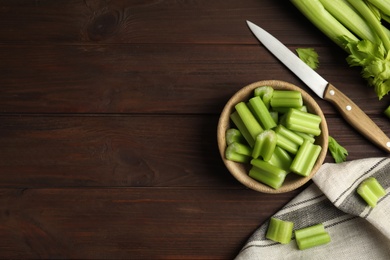 Fresh ripe green celery on wooden table, flat lay. Space for text