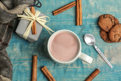 Flat lay composition with hot cocoa drink on wooden background