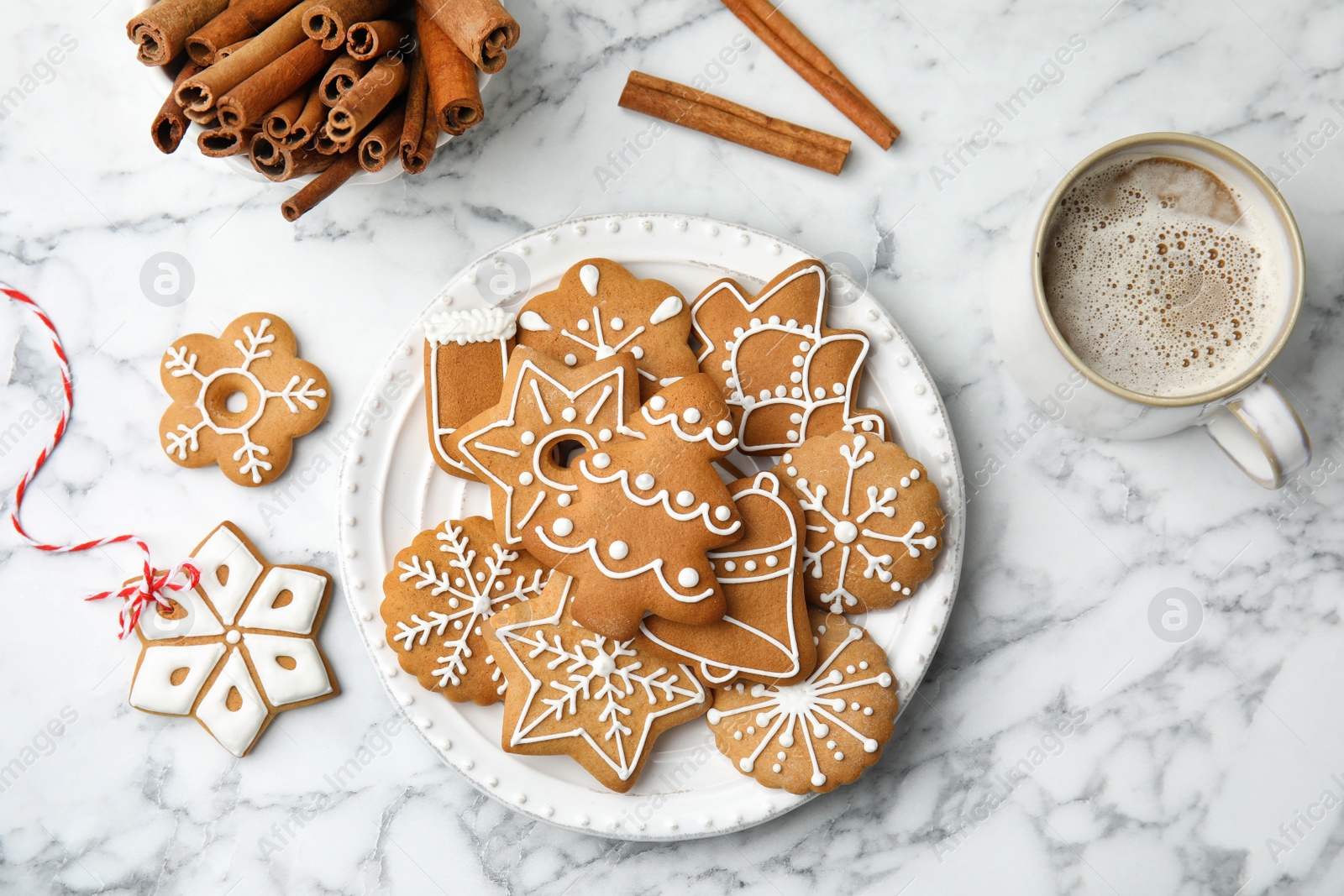 Photo of Plate with tasty homemade Christmas cookies and cup of coffee on table, top view