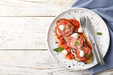 Photo of Flat lay composition with baked eggplant, tomatoes and cheese on wooden table. Space for text