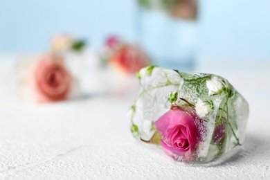 Photo of Floral ice cube on table, closeup. Space for text