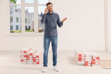 Man talking on phone in apartment during repair