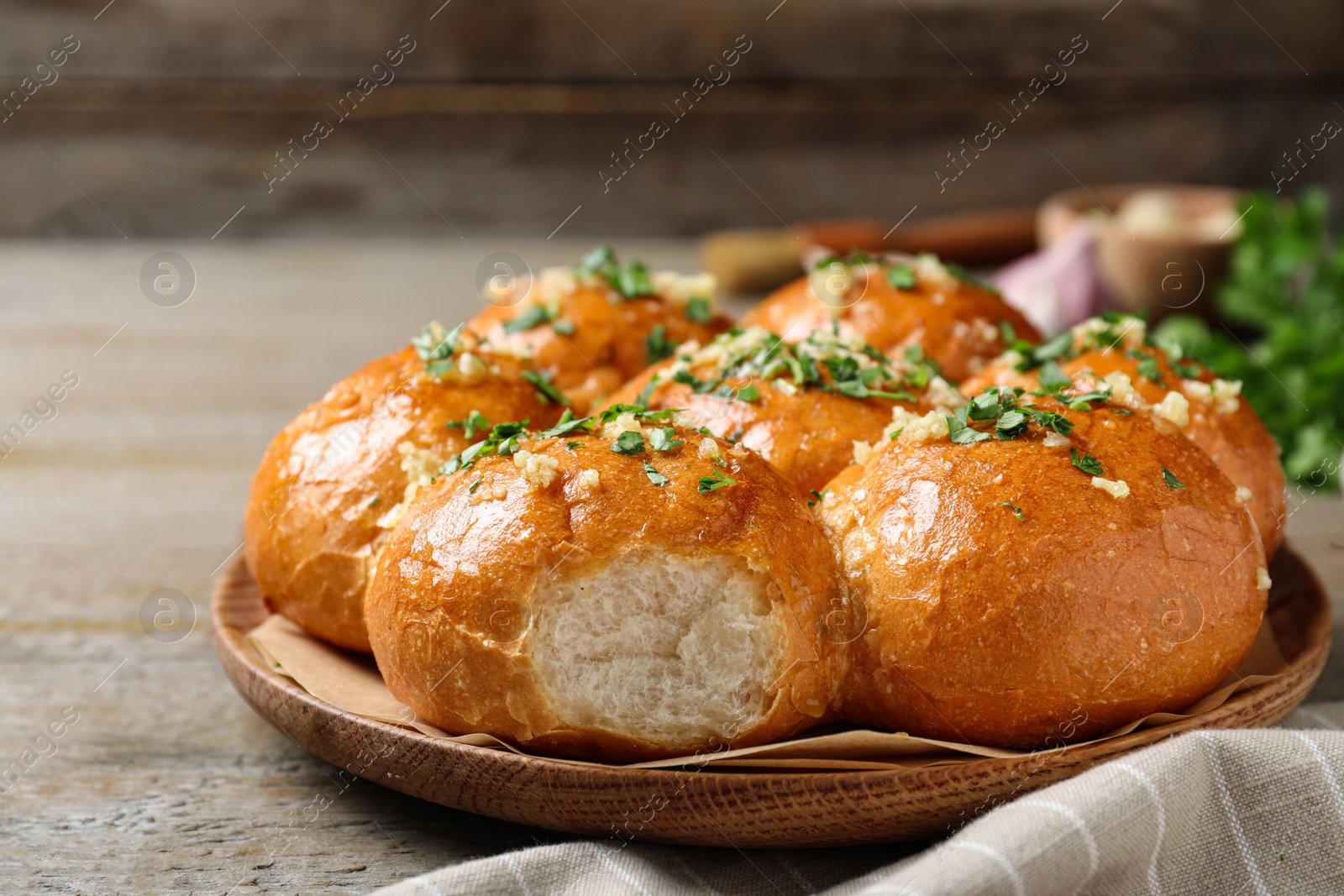 Photo of Traditional Ukrainian garlic bread (Pampushky) on wooden table