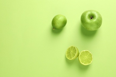 Photo of Flat lay composition with fresh fruits on color background