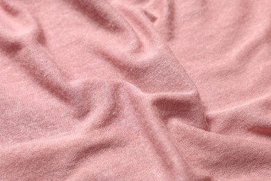 Texture of soft pink crumpled fabric as background, closeup