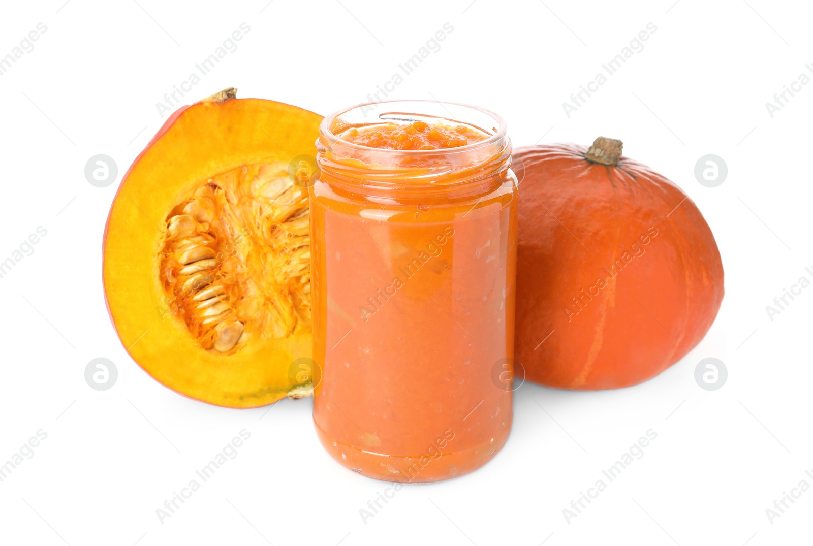 Photo of Jar of pumpkin jam and fresh pumpkins on white background