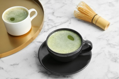 Cups of fresh matcha tea on table