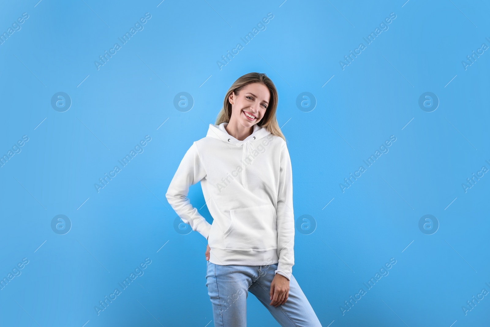 Photo of Portrait of woman in hoodie sweater on color background. Space for design