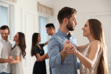 Photo of Lovely young couple dancing together at party. Space for text