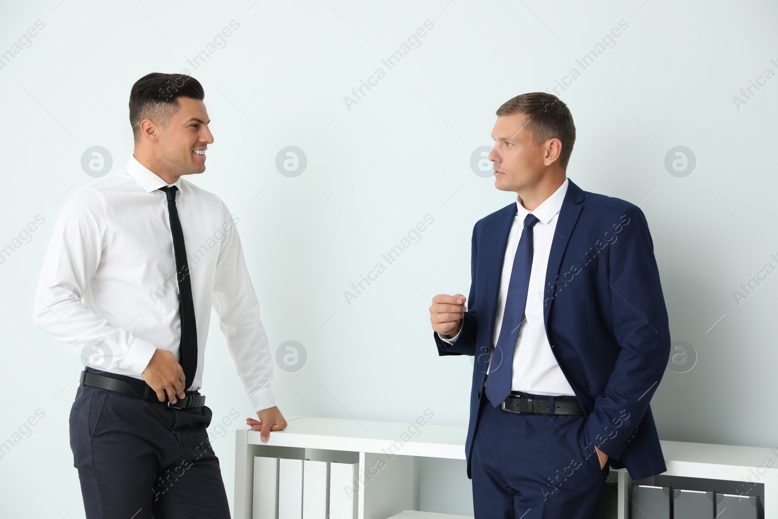 Photo of Office employees talking at workplace during break