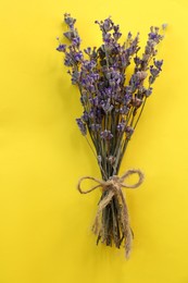 Photo of Bouquet of beautiful lavender flowers on yellow background, top view