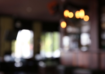 Photo of Blurred view of beer pub with wooden counter