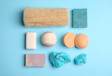 Flat lay composition with bath bombs and toiletries on color background