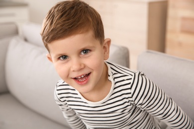 Portrait of little boy laughing at home