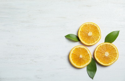 Flat lay composition with fresh oranges on wooden table. Space for text