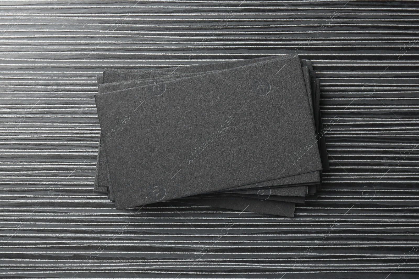 Photo of Blank black business cards on wooden table, top view. Mockup for design