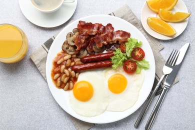 Photo of Delicious breakfast with sunny side up eggs on light table, flat lay