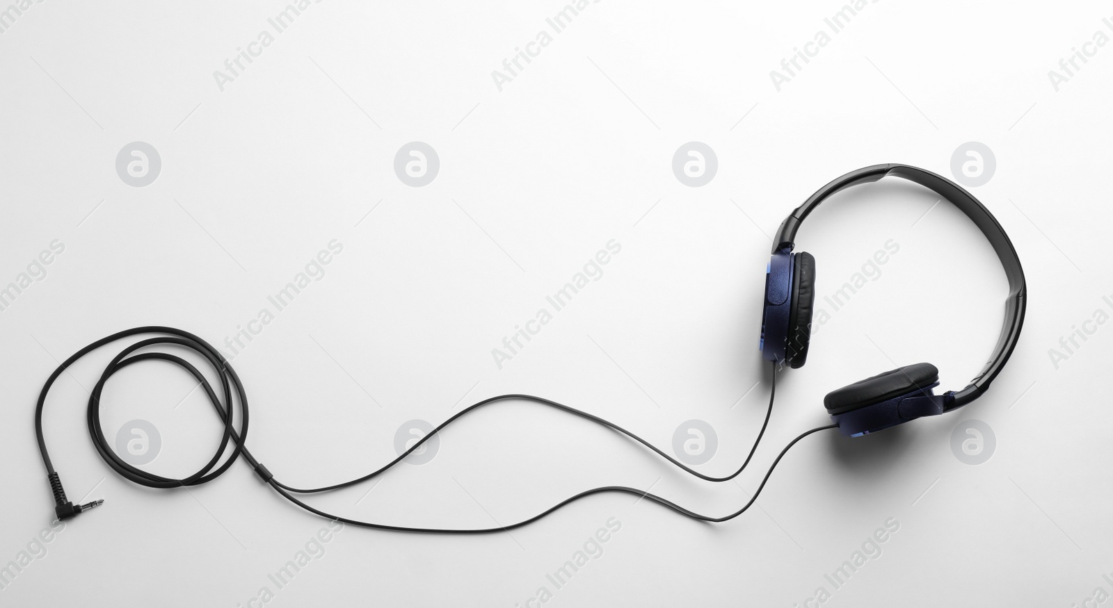 Photo of Stylish modern headphones with earmuffs on white background, top view