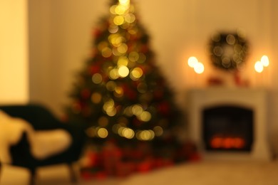 Photo of Blurred view of living room with Christmas tree near fireplace