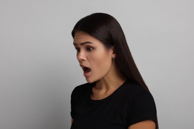 Photo of Personality concept. Emotional woman on grey background