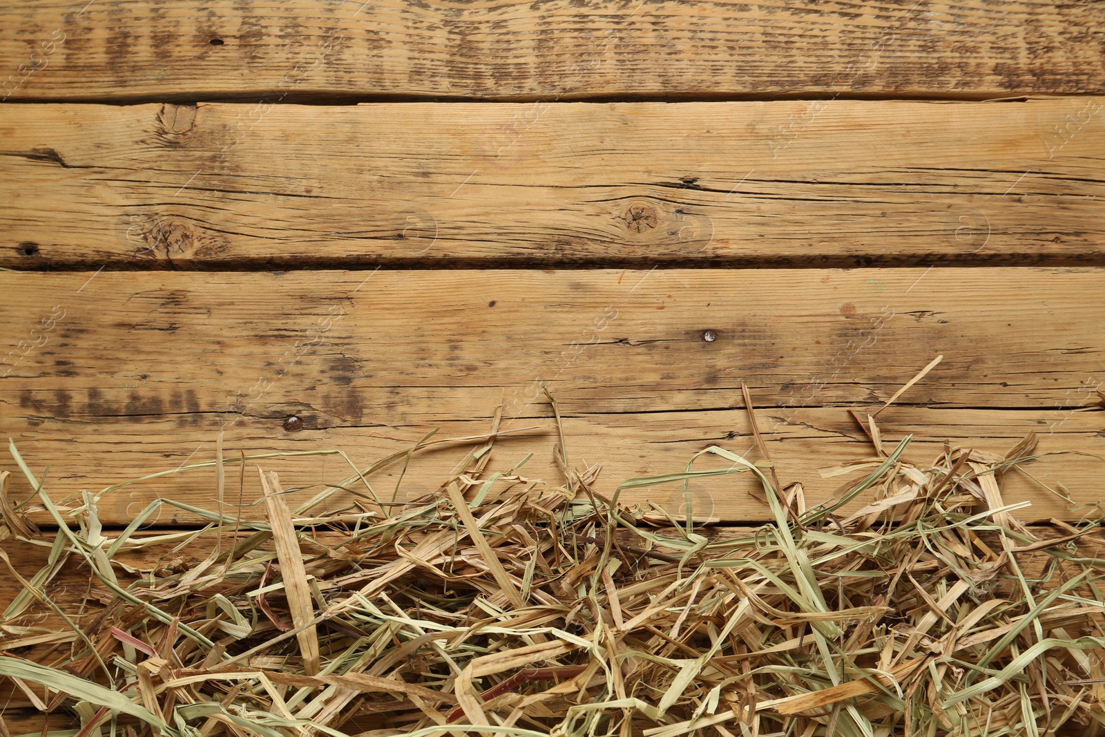 Photo of Dried hay on wooden background, flat lay. Space for text