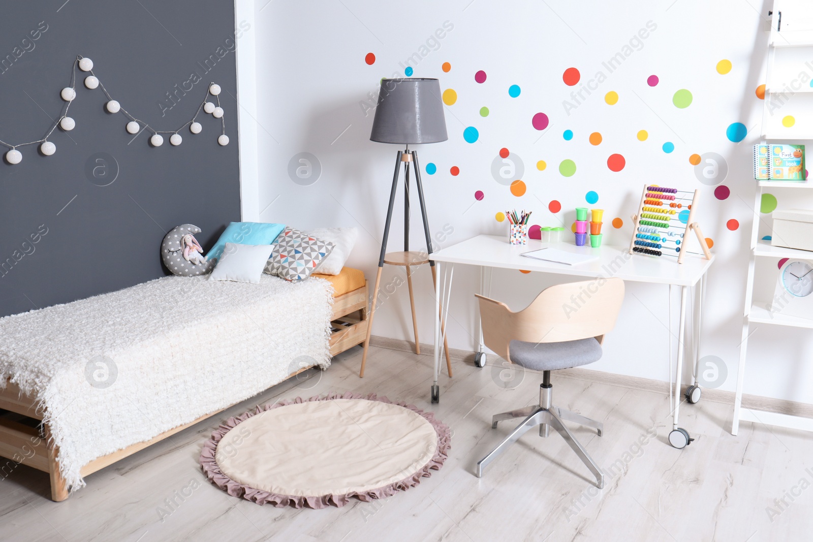 Photo of Modern child room interior with desk and bed