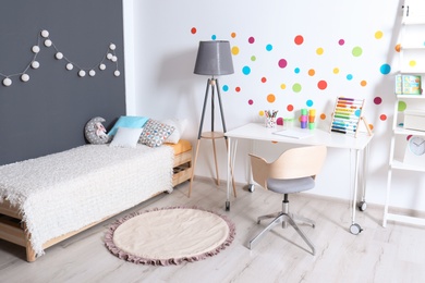 Modern child room interior with desk and bed