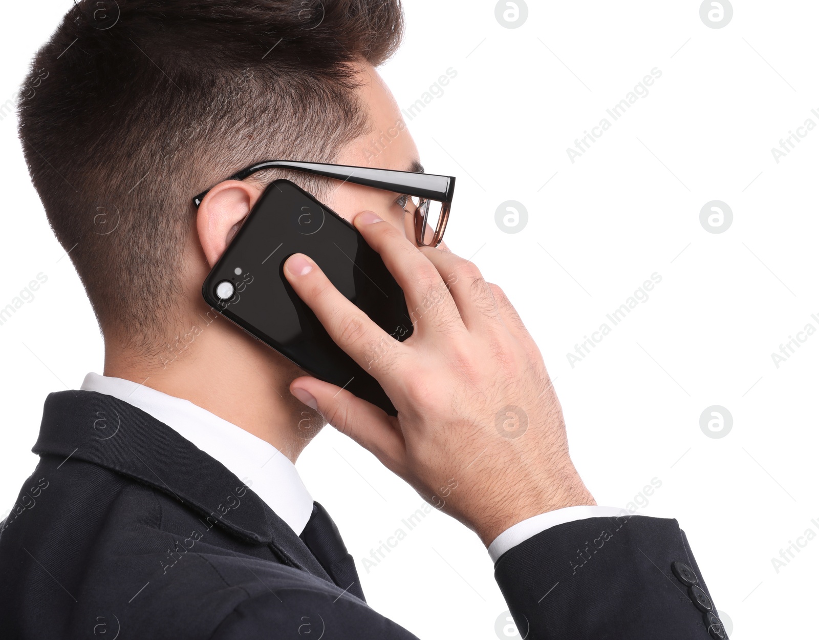 Photo of Young businessman talking on smartphone against white background