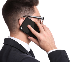 Photo of Young businessman talking on smartphone against white background