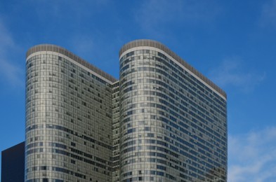 Photo of Exterior of different modern skyscrapers against blue sky, low angle view