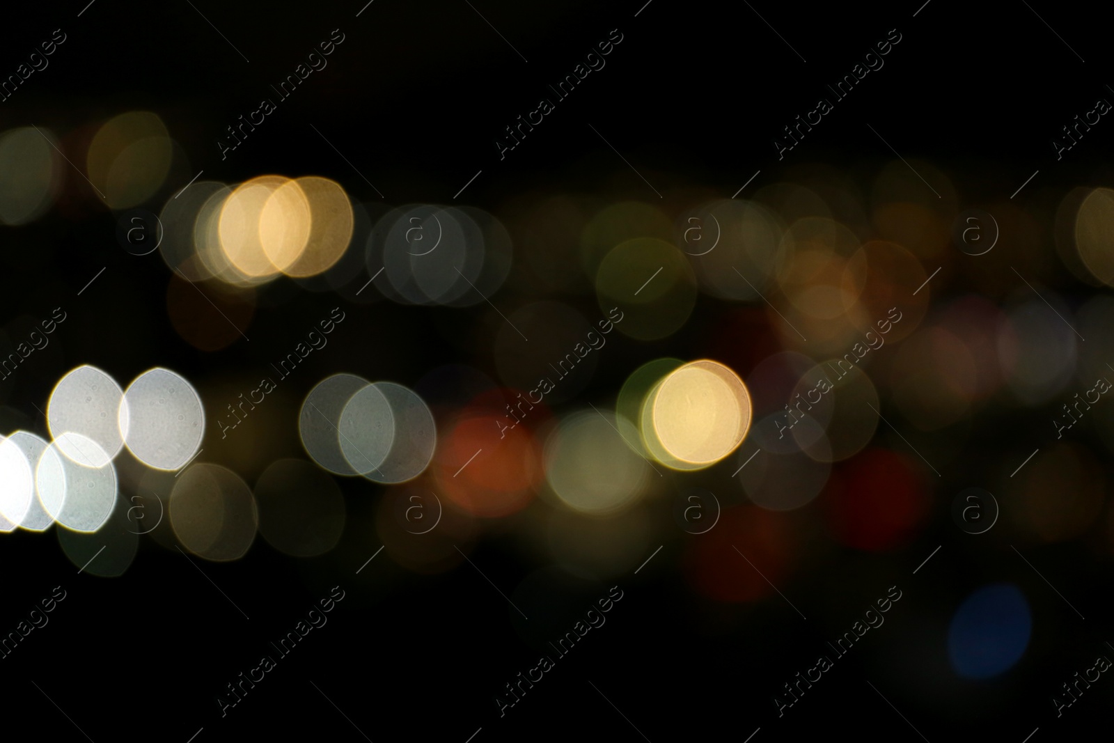 Photo of Blurred view of colorful glowing lights outdoors, bokeh effect