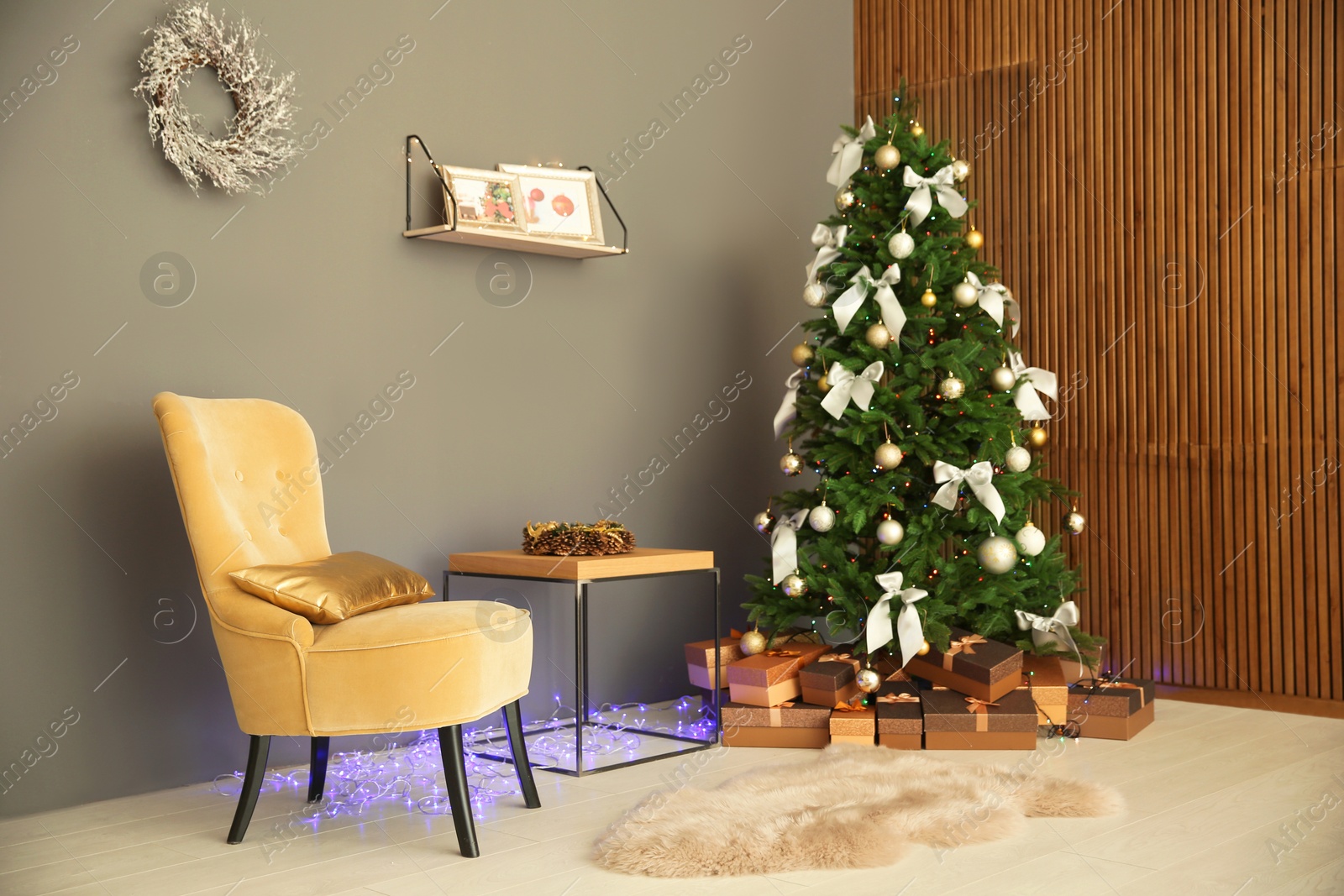 Photo of Room interior with beautiful Christmas tree and gifts