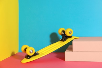 Photo of Yellow skateboard on color background. Space for text