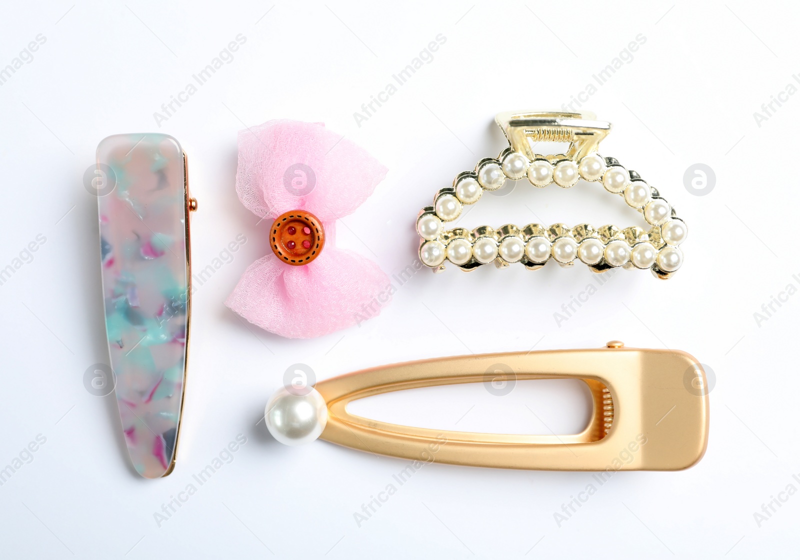 Photo of Stylish hair clips on white background, top view