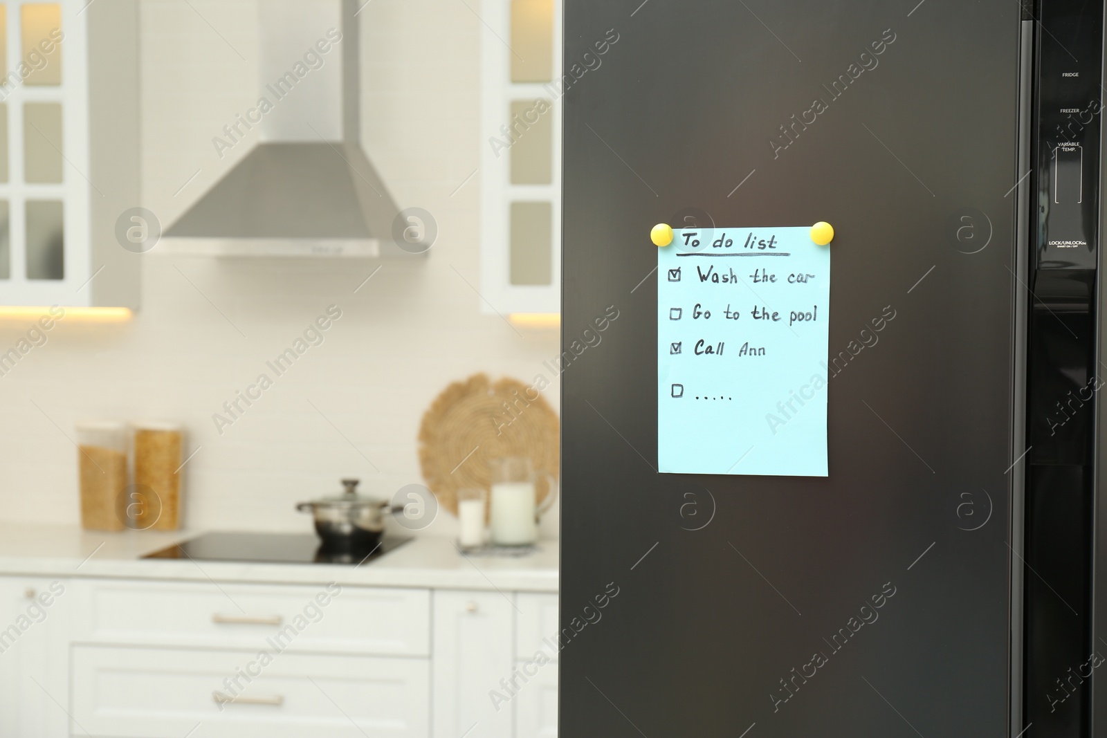 Photo of To do list on fridge in kitchen. Space for text