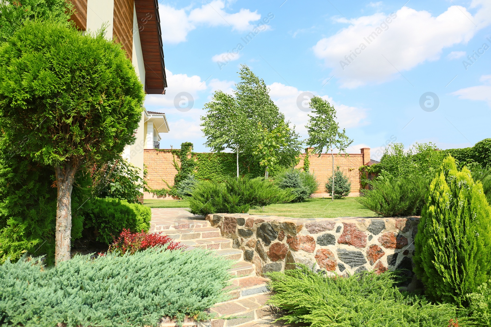 Photo of Landscape with modern house and beautiful garden on sunny day