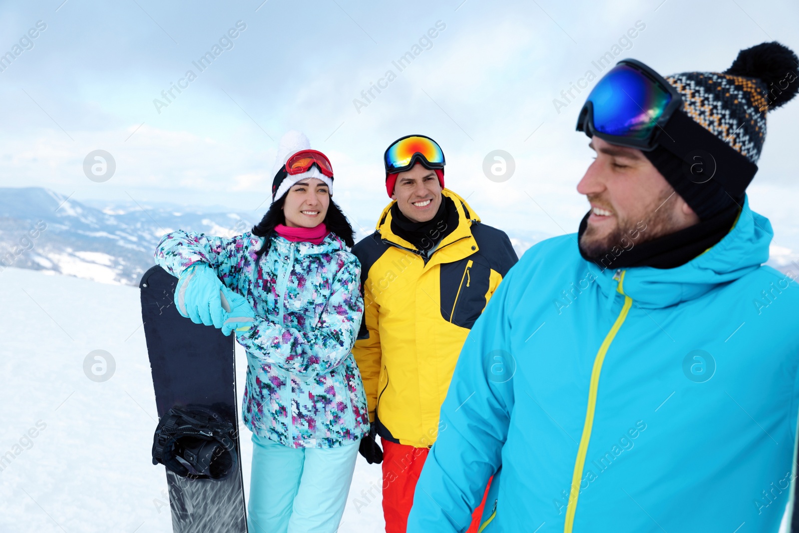 Photo of Group of friends with equipment in snowy mountains. Winter vacation