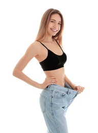 Photo of Slim woman in oversized jeans on white background. Perfect body