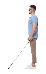 Photo of Young blind person with long cane walking on white background