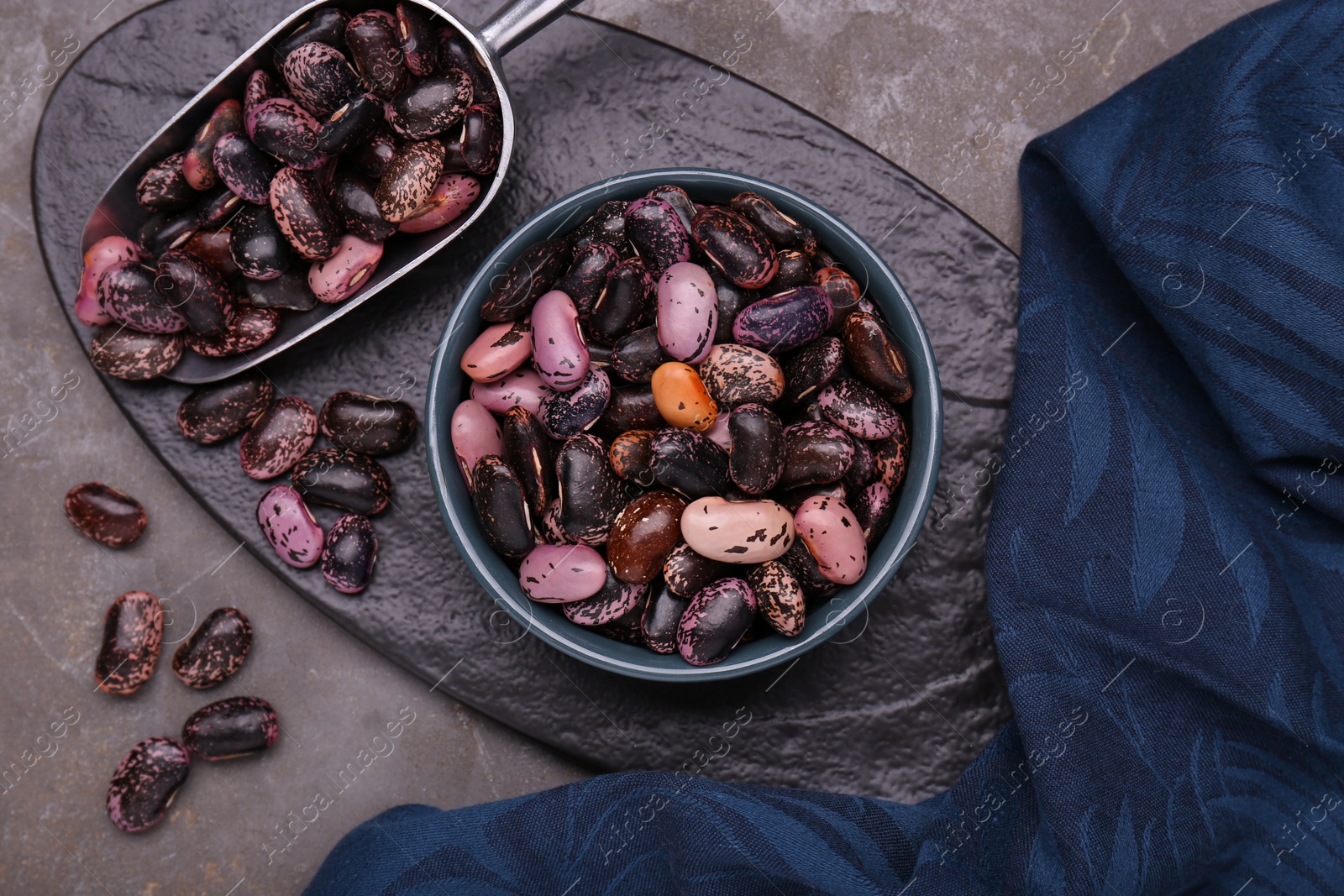 Photo of Many dry kidney beans on grey table, flat lay