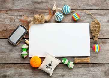 Photo of Flat lay composition with cat accessories on wooden background