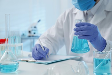 Photo of Scientist working with sample in laboratory, closeup. Medical research