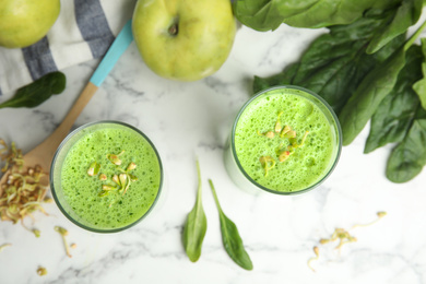 Photo of Green buckwheat smoothie on white marble table, top view