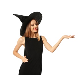 Photo of Beautiful young woman wearing witch costume for Halloween party on white background